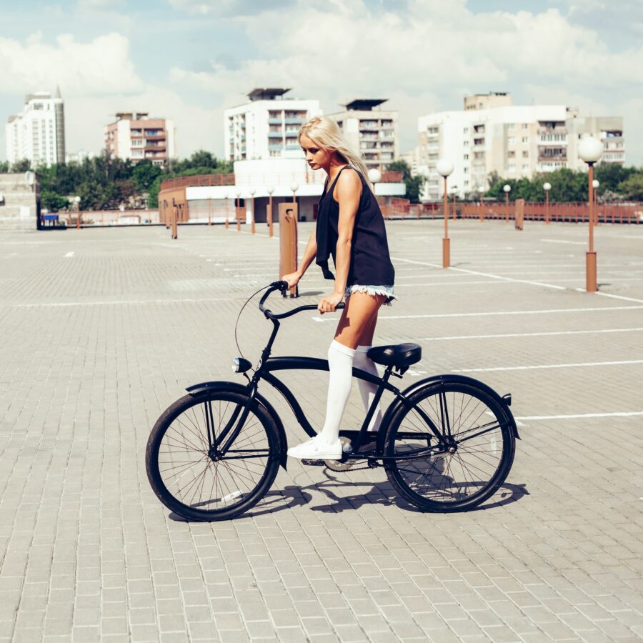 beautiful blonde head woman on bike in city
